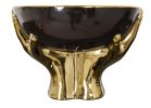 Black Bowl Held by Gold Hands